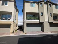 Modern townhome exterior features a neutral color scheme and attached garages at 6830 Truffle Gray St, Las Vegas, NV 89148