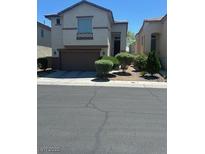 Two-story home featuring a two-car garage and manicured landscaping at 7047 Sombra Way, Las Vegas, NV 89113