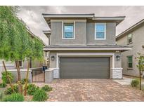 Charming two-story home featuring a two-car garage and nicely landscaped front yard at 707 Cottonwood Hill Pl, Henderson, NV 89011