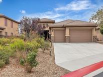 Charming two-story home with desert landscaping and a large three-car garage at 7505 Java Sparrow St, North Las Vegas, NV 89084