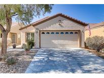 Charming single-story home with a two-car garage and well-maintained desert landscaping at 7669 Fieldfare Dr, North Las Vegas, NV 89084