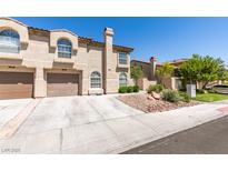 Inviting townhome with a two-car garage and desert landscaping for low maintenance appeal at 7732 Almeria Ave, Las Vegas, NV 89128