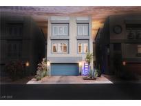 Contemporary three-story home featuring a blue garage door and modern landscaping at 8113 Misty Canyon Ave, Las Vegas, NV 89113
