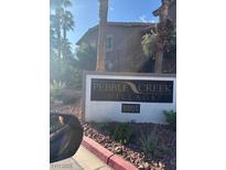 Pebble Creek Village community sign with address amid palm trees at 8805 Jeffreys St # 1112, Las Vegas, NV 89123