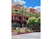 Attractive condos with balconies and rooftop patios, surrounded by palm trees and lush landscaping at 91 E Agate Ave # 204, Las Vegas, NV 89123