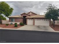 Charming single-story home features a two-car garage, desert landscaping, and a tile roof at 9524 Tyler Rose St, Las Vegas, NV 89178