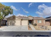 Charming single-story home with three-car garage, desert landscaping and a beautiful tile roof at 10311 Slope Ridge St, Las Vegas, NV 89131