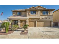 Charming two-story home featuring desert landscaping, a tiled roof, and a spacious three-car garage with an extended driveway at 1191 Starstone Ct, Henderson, NV 89014
