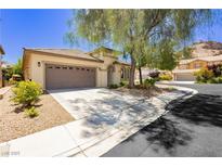 Charming single-story home boasting a well-manicured front yard and an attached two-car garage at 145 Austin Rose Ave, Henderson, NV 89002