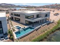 Stunning modern home with a pool and hot tub overlooking the lake and mountains at 1548 Pleasant Bay Ct, Henderson, NV 89011