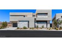 Modern home featuring a two-car garage, a concrete facade, and desert landscaping at 1548 Pleasant Bay Ct, Henderson, NV 89011