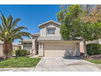 Charming home featuring a well-maintained lawn, desert landscaping, and a two-car garage at 2470 Lower Meadows Ave, Henderson, NV 89052
