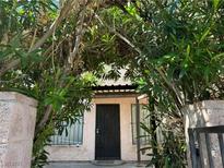 Charming front entrance with a security door and lush greenery surrounding the entry at 4338 Caliente St # 8, Las Vegas, NV 89119