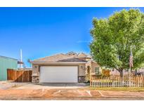 Charming single-story home featuring a two-car garage, neat landscaping and a quaint wooden fence at 474 Adelle Ave, Overton, NV 89040