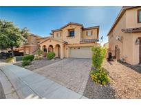 Charming two-story home featuring an arched entryway and a well-manicured front yard at 4937 Teal Petals St, North Las Vegas, NV 89081