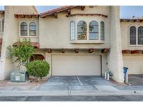 Charming two-story townhome featuring a spacious garage and well-maintained landscaping at 4998 Schumann Dr, Las Vegas, NV 89146