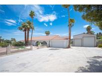 Expansive front yard and driveway leading to a charming single-story home with a detached garage at 5515 Coley Ave, Las Vegas, NV 89146