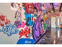 Hallway with custom graffiti art and epoxy flooring at 5626 Deer Creek Falls Ct, Las Vegas, NV 89118