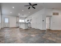 Open floor plan featuring a spacious kitchen with ample cabinets and a kitchen island at 6436 Point Break St, North Las Vegas, NV 89084