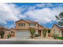 Charming two-story home featuring a tile roof, manicured landscaping, and a two-car garage at 7888 Bonaventure Dr, Las Vegas, NV 89147