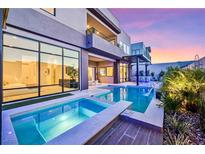 Modern backyard oasis featuring a sparkling pool, spa, and sleek contemporary design at 10718 Desert Heights Ave, Las Vegas, NV 89135