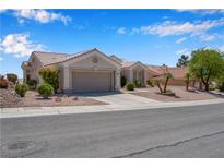Charming single-story home featuring desert landscaping and a two-car garage at 11032 Mission Lakes Ave, Las Vegas, NV 89134