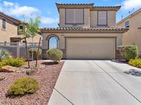 Charming two-story home with a well-maintained front yard and a two-car garage at 1124 Aspen Cliff Dr, Henderson, NV 89011