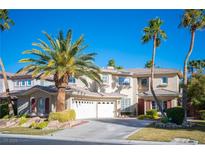 Beautiful two-story home showcasing a manicured lawn, mature palm trees, and a spacious three-car garage at 204 N Ring Dove Dr, Las Vegas, NV 89144