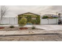 Charming home featuring rock landscaping and a unique ivy-covered facade for added curb appeal at 2060 Toiyabe St, Las Vegas, NV 89156
