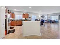 Spacious kitchen features a breakfast bar that seamlessly connects to the living and dining areas at 2613 Velodrome Ct, Henderson, NV 89044