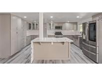 Spacious kitchen with a large island, stainless steel appliances, and white countertops at 326 Fuente Dr, Henderson, NV 89014