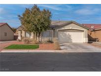Inviting single-story home featuring a two-car garage and a well-maintained front yard at 3713 Nairobi Ln, North Las Vegas, NV 89032
