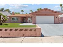 Single-story home with a spacious driveway, two-car garage, and well-maintained artificial lawn at 4115 Ridgewood Ave, Las Vegas, NV 89120