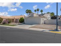Single story home with desert landscaping and an attached two car garage at 4644 Canna Dr, Las Vegas, NV 89122
