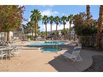 Community pool and spa surrounded by palm trees and lounge chairs at 5655 E Sahara Ave # 1037, Las Vegas, NV 89142
