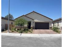 Charming single-story home with a well-maintained front yard and a brick-paved driveway and front walkway at 6009 La Coste St, North Las Vegas, NV 89081
