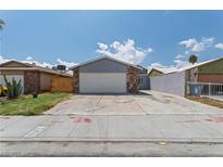 Charming single-story home with a two-car garage and spacious concrete driveway at 6017 Natures Dr, Las Vegas, NV 89122