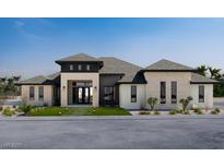 Stunning single story home with modern architecture, manicured lawn and stone accents at 641 Patti Ann Woods, Henderson, NV 89002