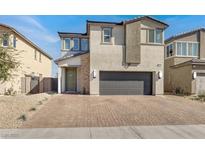 Charming two-story home with a brick paved driveway and a two car garage in a residential neighborhood at 6618 Palm Branch St, North Las Vegas, NV 89086