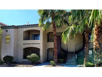 Inviting condo complex featuring lush landscaping and convenient stair access to upper-level units at 7885 W Flamingo Rd # 2003, Las Vegas, NV 89147