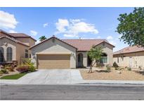 Charming single-story home featuring desert landscaping, a two-car garage, and a classic tile roof at 1006 Cove Palisades Dr, North Las Vegas, NV 89031