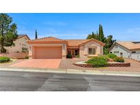 Charming one-story home features a terra cotta roof, desert landscaping, and a two-car garage at 10636 Argents Hill Dr, Las Vegas, NV 89134