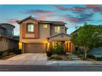 Charming two-story home featuring a well-manicured front yard and a two-car garage in a residential neighborhood at 11228 Hedgemont Ave, Las Vegas, NV 89138