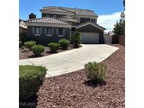 Charming two-story home features a well-manicured front yard, concrete driveway, and a two-car garage at 11278 Tenza Ct, Las Vegas, NV 89141