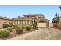 Charming stucco home with a tile roof and a two car garage on a sunny day at 11278 Tenza Ct, Las Vegas, NV 89141