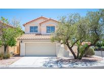 Charming two-story home featuring a well-maintained lawn and a two-car garage at 1620 Western Lily St, Las Vegas, NV 89128