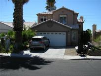 Two-story home featuring a tile roof, two-car garage, and low-maintenance landscaping at 1927 Raspberry Hill Rd, Las Vegas, NV 89142