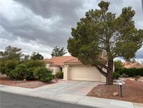 Charming single-story home with a terracotta roof, landscaped front yard, and a spacious two-car garage at 2801 Golfside Dr, Las Vegas, NV 89134