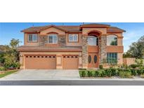 Charming two-story home featuring a three-car garage and attractive stone accents at 281 Powerbilt Ave, Las Vegas, NV 89148