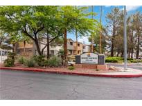 Community entrance with lush landscaping and Desert Shores Villas signage for a welcoming appeal at 3151 Soaring Gulls Dr # 2081, Las Vegas, NV 89128